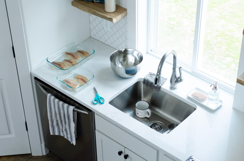 Metal sink sourronded by fish and cooking equipment - Photo by Taylor Wilcox on Unsplash